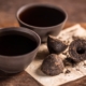 Cups of black tea with pressed tea leaves