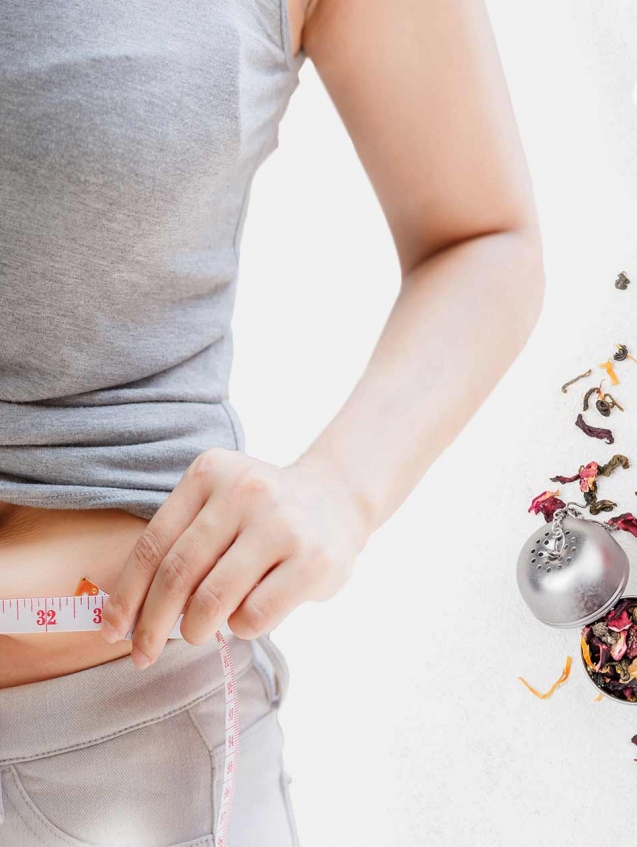 A woman measuring her waist
