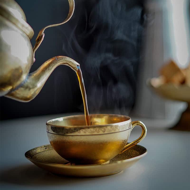 Pouring tea into a cup